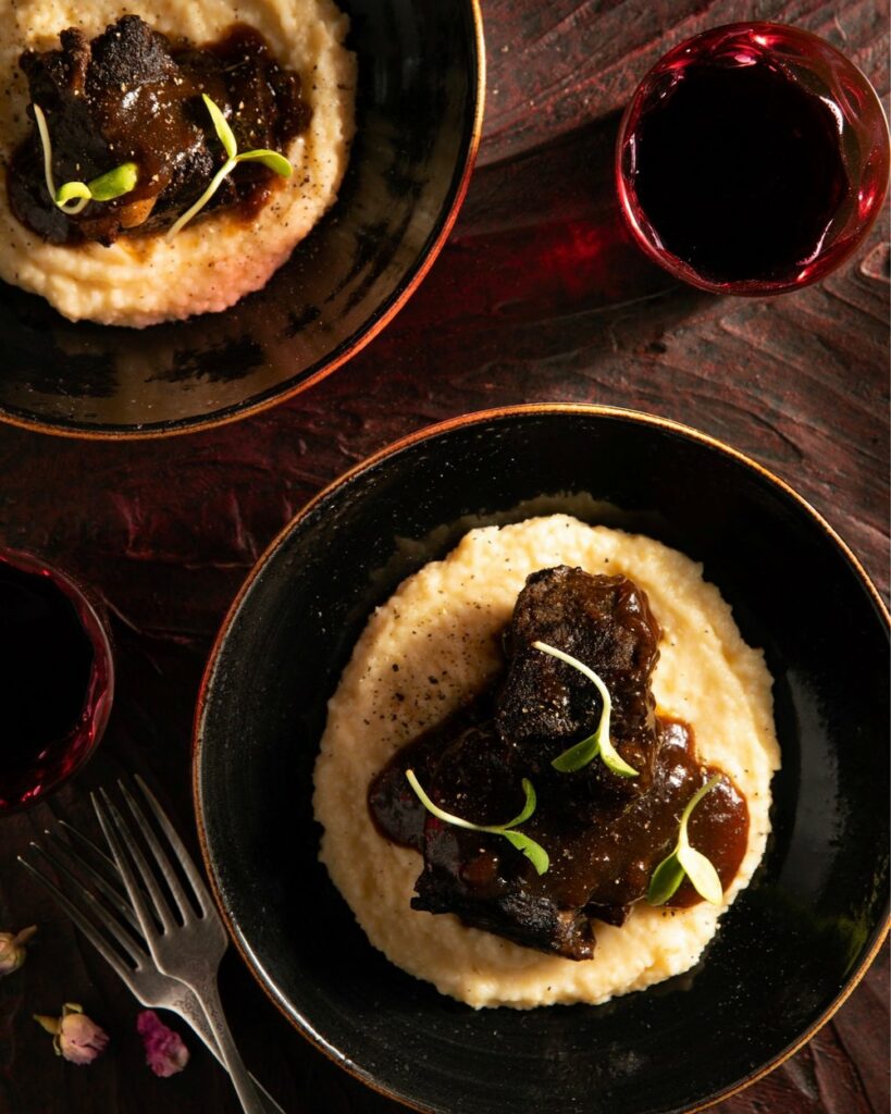 Tender braised beef atop cheesy grits.