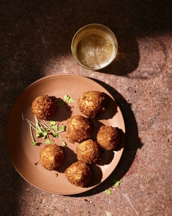 Coxinha+De+Frango+TABLE+Magazine Coxinha De Frango, deep-fried balls of dough filled with seasoned and shredded chicken, popular in Brazilian cafés.