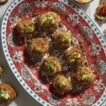 Elevate your appetizer menu with these bite-sized crab cakes on a red and blue plate.