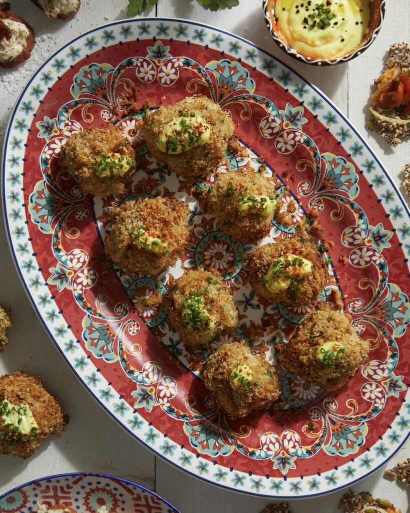 Elevate your appetizer menu with these bite-sized crab cakes on a red and blue plate.