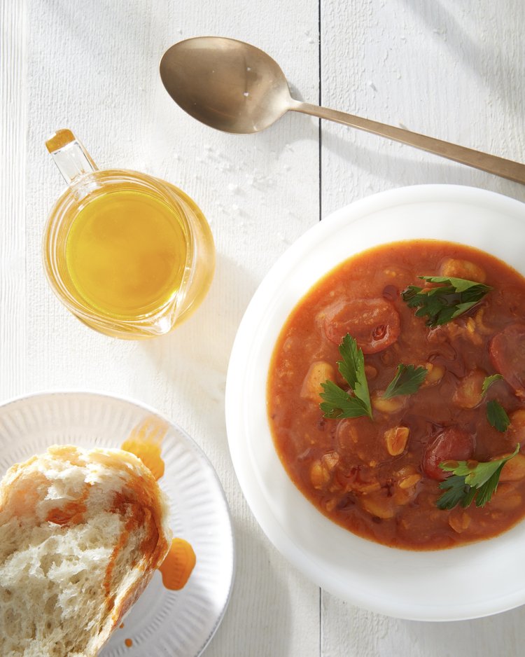 White bean tomato stew served in a dish alongside other dishes.
