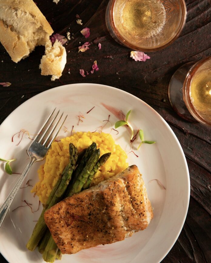 Salmon+With+Saffron+Risotto+and+Asparagus+TABLE+Magazine A filet of tender, flaky salmon over creamy saffron risotto.