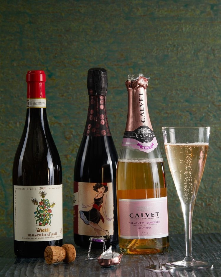 Three bottles of wine and a glass of champagne.