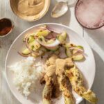 Chicken Satay on a white plate.