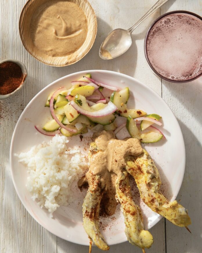 Chicken Satay on a white plate.