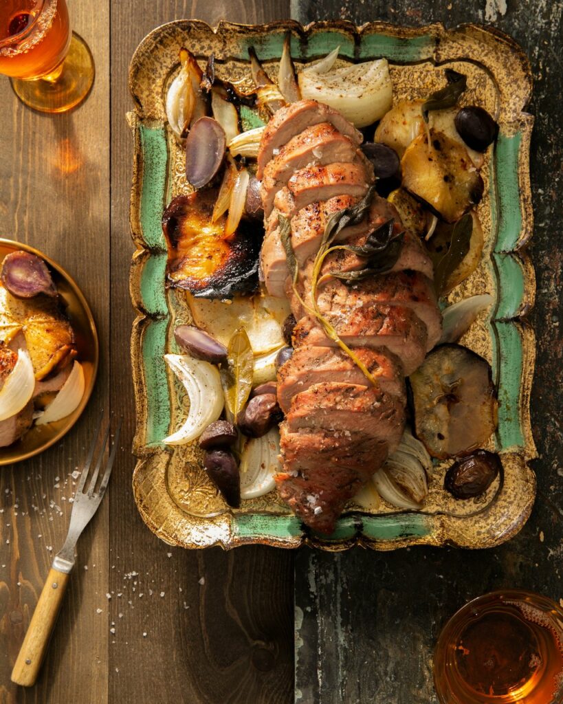 An aerial shot of Cider-Glazed Pork Loin with Roasted Apples and Potatoes in a roasting tray.
