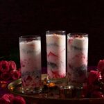 Three tall glasses with a layered Falooda dessert for Diwali.