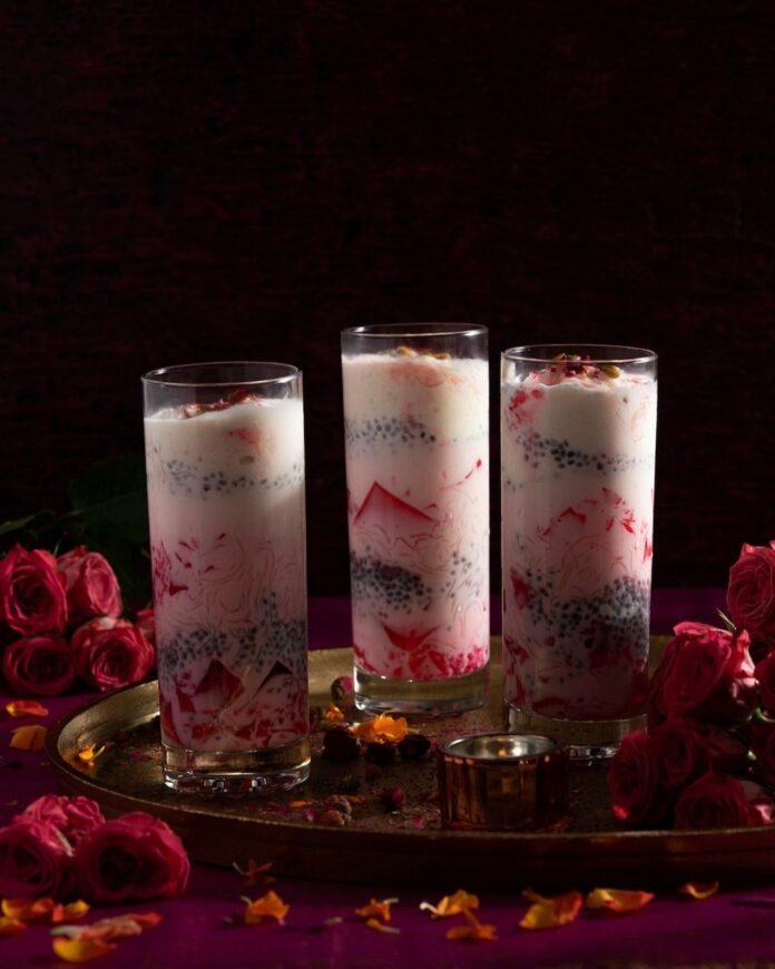 Three tall glasses with a layered Falooda dessert for Diwali.