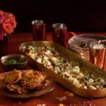 Diwali Onion Bhaji and Dahi Papdi Chaat on gold serve ware with red accent decorations.