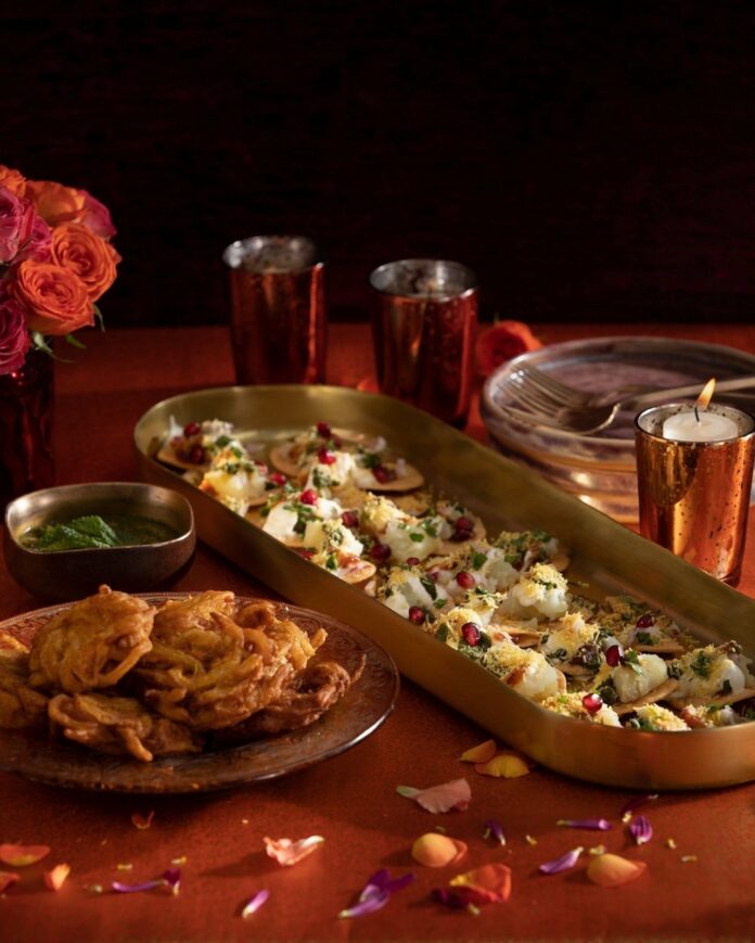 Diwali Onion Bhaji and Dahi Papdi Chaat on gold serve ware with red accent decorations.