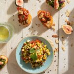 A grilled sweet corn salad lays on a blue bowl.