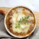 A large bowl of french onion soup.