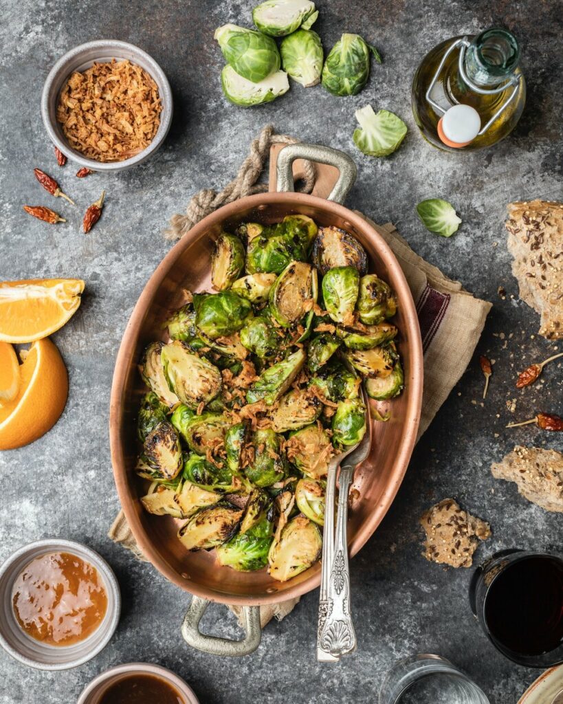 An aerial view of a bowl of Brussels Sprouts covered in an Orange Apricot Sauce.