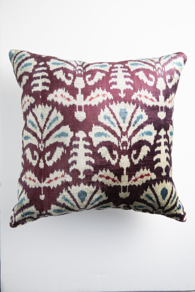 A plum-color Ikat pillow from Carte Blanche.