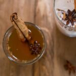 Haitian Ginger Tea with a cinnamon stick served in a glass