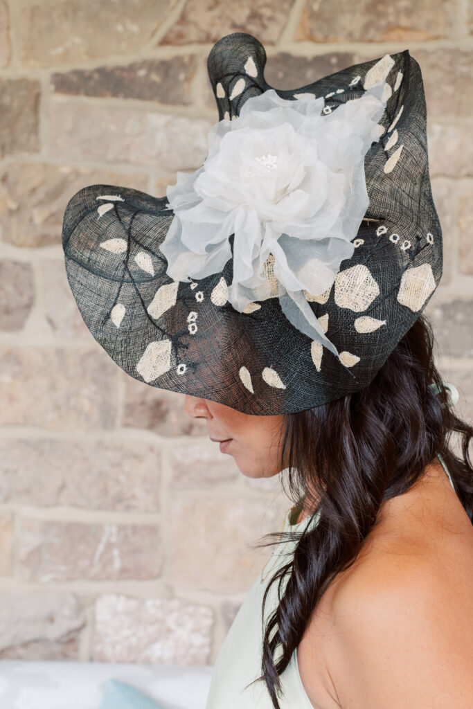 black and white extravagant fascinator hat with a very large net white flower for the Kentucky derby
