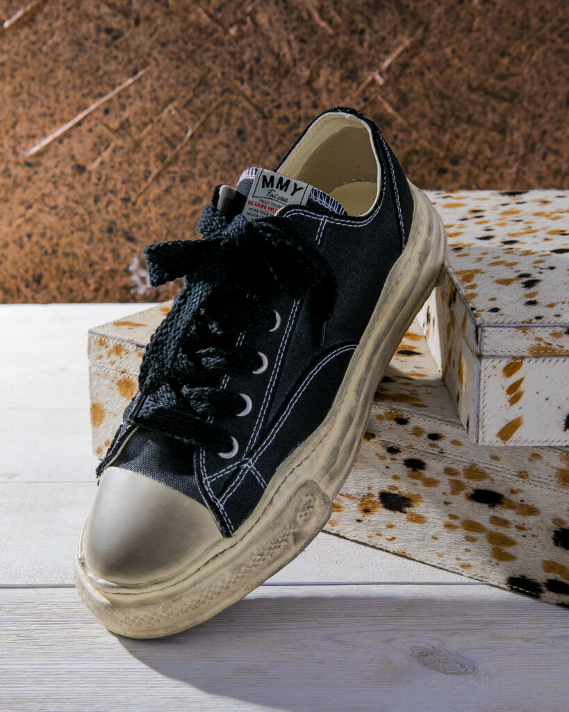 A photo of a black canvas sneaker.