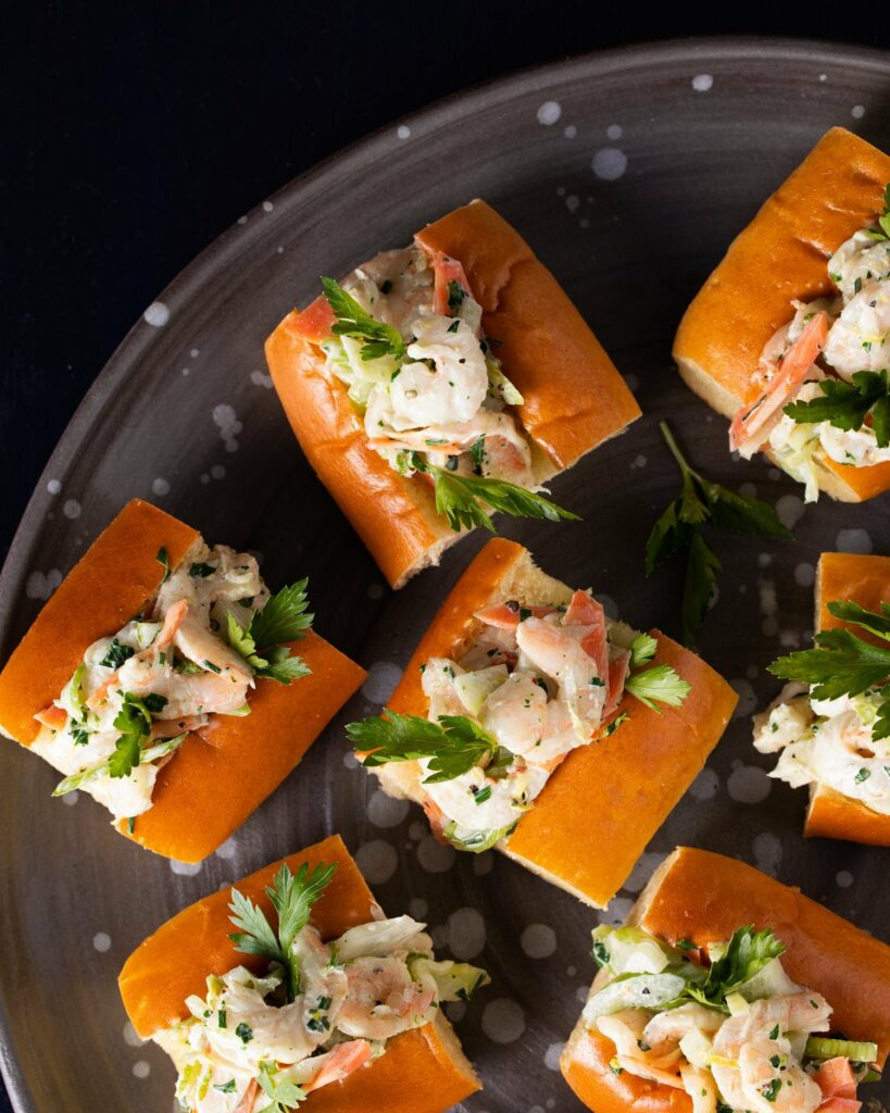 A plate of mini shrimp sandwiches. 