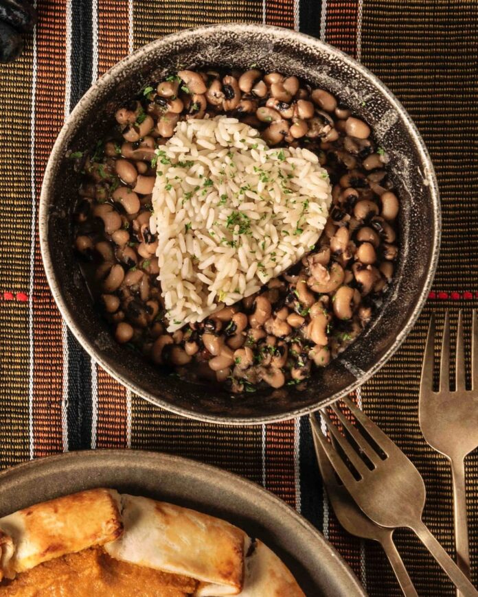 Black Eyed Peas and Rice served in a bowl with three forks on the side