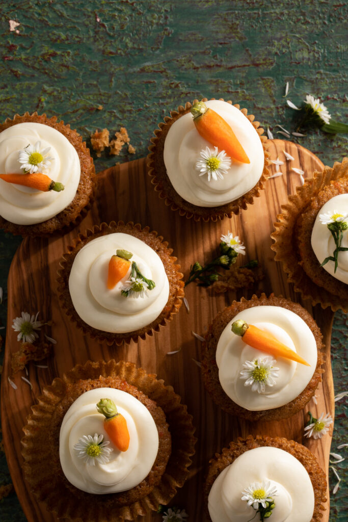 A flat-lay view of seven carrot miso cupcakes.