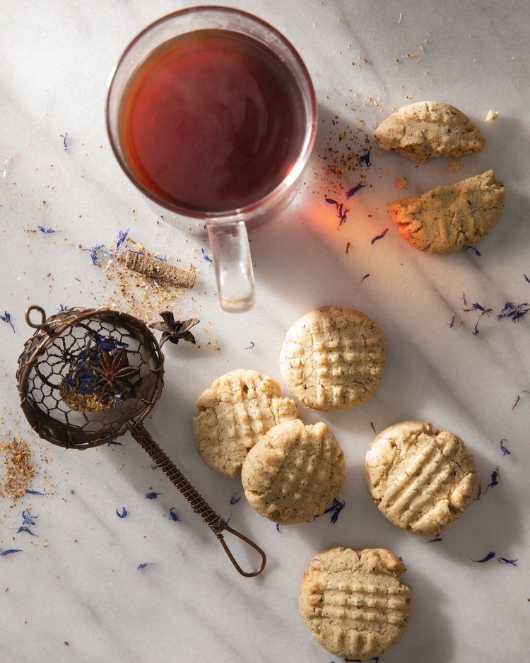 a cup of tea and some cookies on a table.