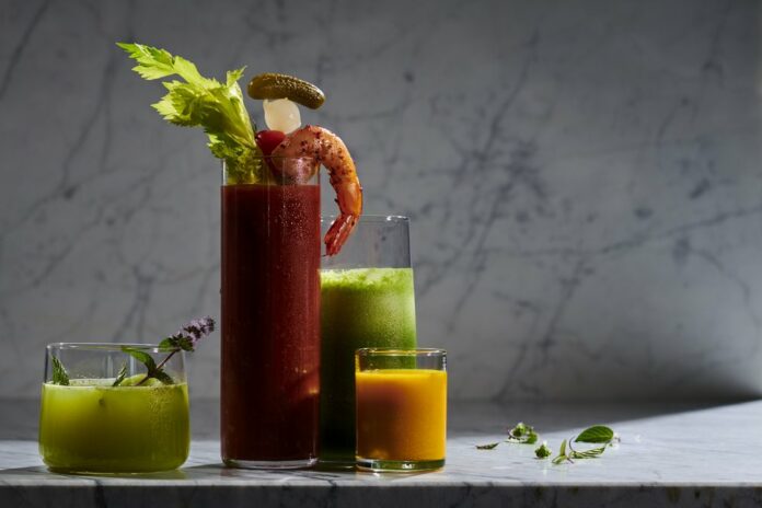 4 glasses of different sizes almost filled with green, red, and orange-colored healthy shots. Best Mocktail Recipes