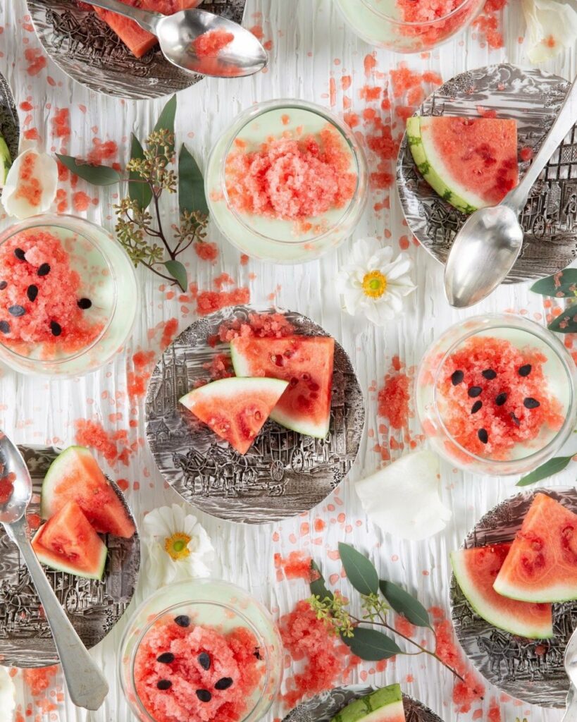 Lime Posset & Watermelon Granita in small glass dishes with spoons.