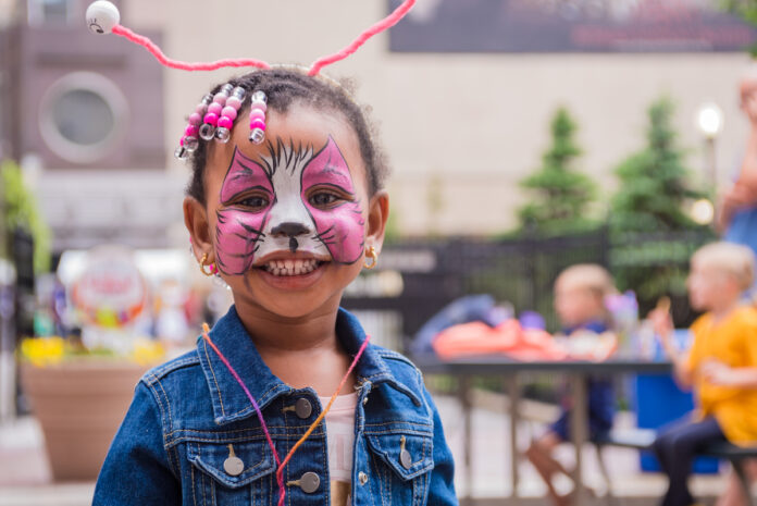 EQT Children's Theatre Festival A black child with a painted pink tiger face at the EQT Children's Theatre Festival, Pittsburgh Happenings