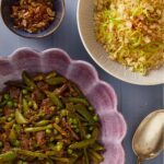 Spring Beef Stir Fry in a purple bowl cut in half. Another bowl of rice cut in half, a half-cut spoon, and a smaller bowl with a side dish.
