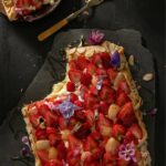 Strawberry Honey Galette on a broken slab with a fork and a 1/4th of a plate on the side