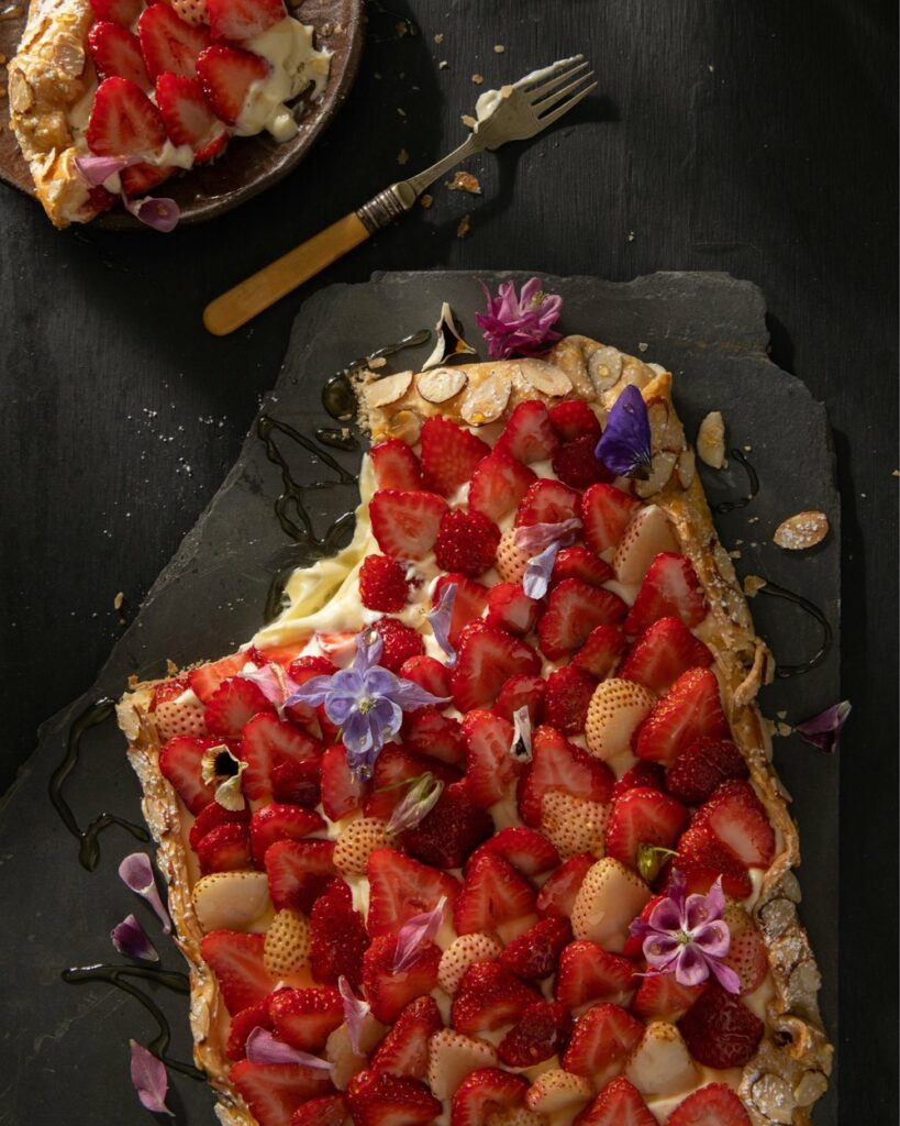 Strawberry Honey Galette on a broken slab with a fork and a 1/4th of a plate on the side