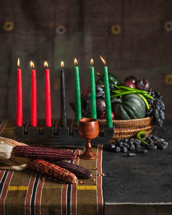 The Principles of Kwanzaa A kinara with seven candles, a wooden cup for the ancestors, corn for the children, and harvest bounty to show respect for the people who grew them, are all symbols of Kwanzaa, a holiday that celebrates unity and community.
