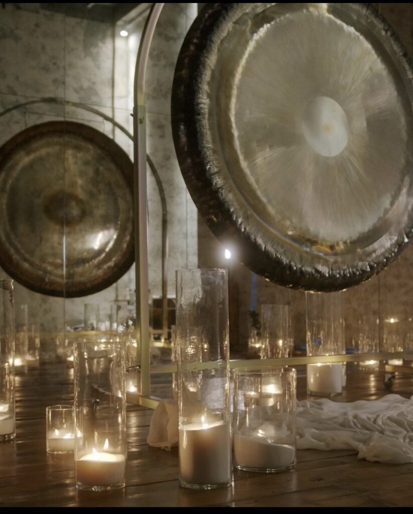 An image of a group of lit candles and gongs to illustrate an alternative therapy listicle.
