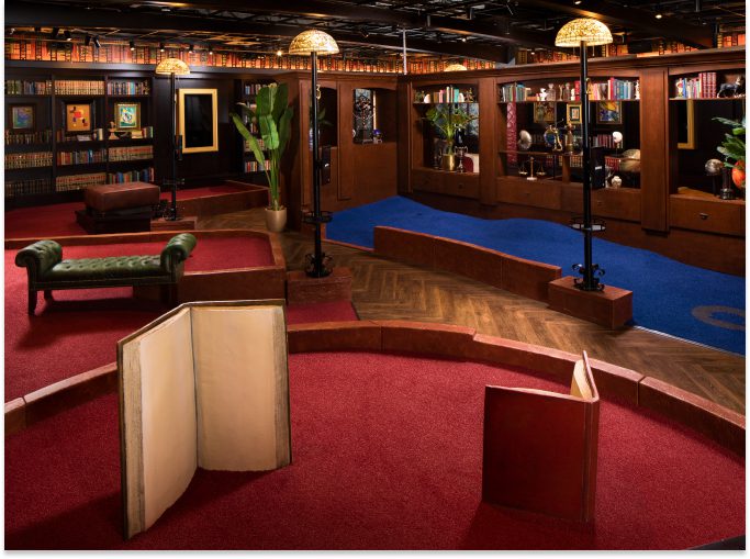 An indoor mini-golf course styled to look like a library at Puttery.