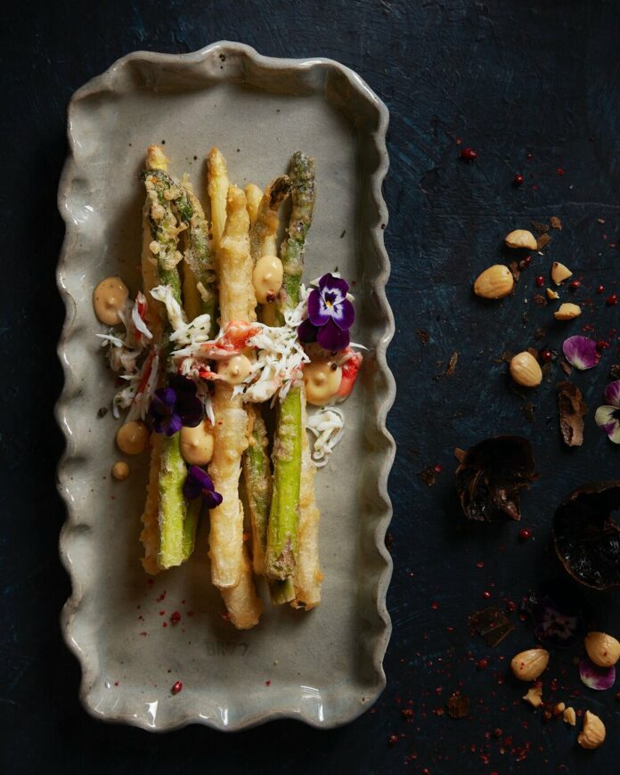Crispy and Delicious Asparagus Tempura on a grey platter with a king crab salad.