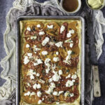 Heirloom Tomato & Goat Cheese Tart in a steel dish on a thin cloth.