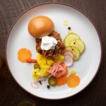 Lamb Sloppy Joes deconstructed on a white plate.
