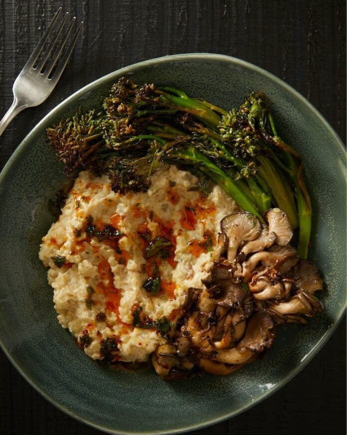 Riced Cauliflower Risotto in a green dish with a fork on the side.