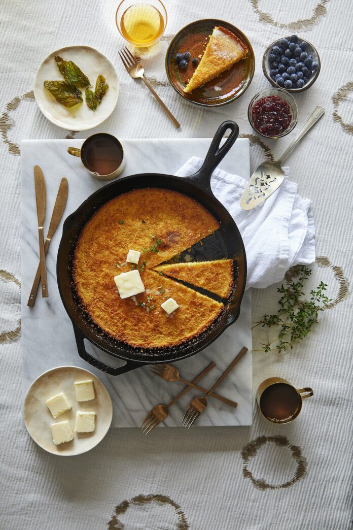 Weatherbury Farm’s Buttermilk Cornbread on a skillet with berries, jam, and butter on the side