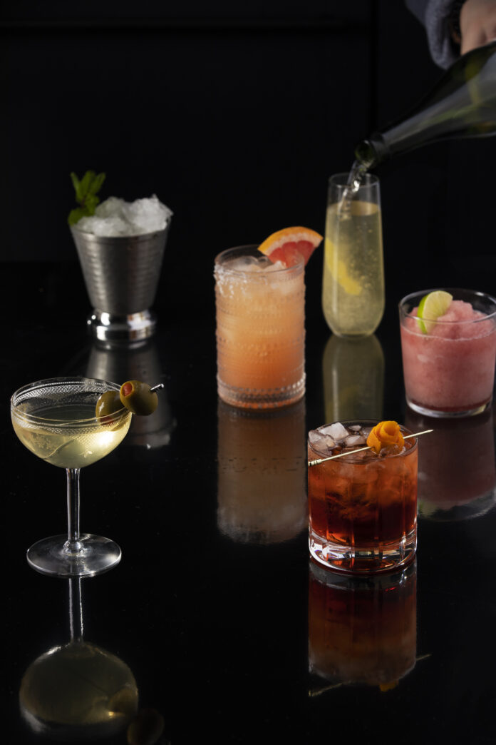 six classic cocktails of various colors sit in glasses of different shapes and sizes. classic cocktail recipes