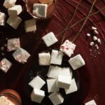 Homemade boozy marshmallows infused with a delightful blend of spirits, adding a touch of indulgence and flavor to your favorite hot beverages or enjoyed on their own as a delightful treat.