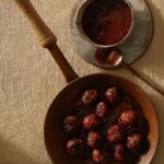 Flavorful meatballs in cranberry gojuchang sauce, creating a harmonious blend of sweet, savory, and spicy flavors, perfect for a satisfying and delicious meal.