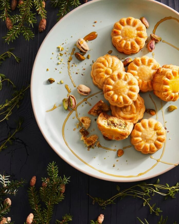 Delicate and flavorful mooncakes filled with a delightful blend of spiced pistachios, capturing the essence of traditional and festive Asian cuisine.