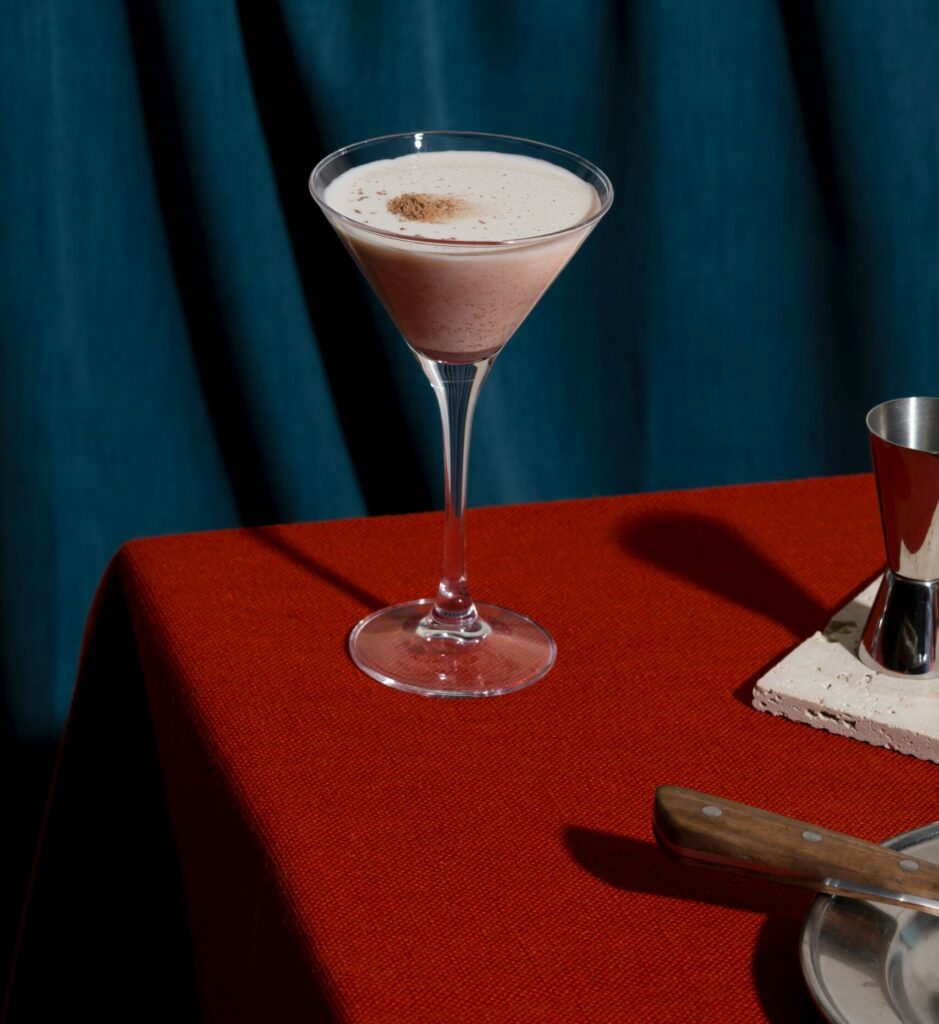 chocolate martini on the edge of a table dressed in a red tablecloth