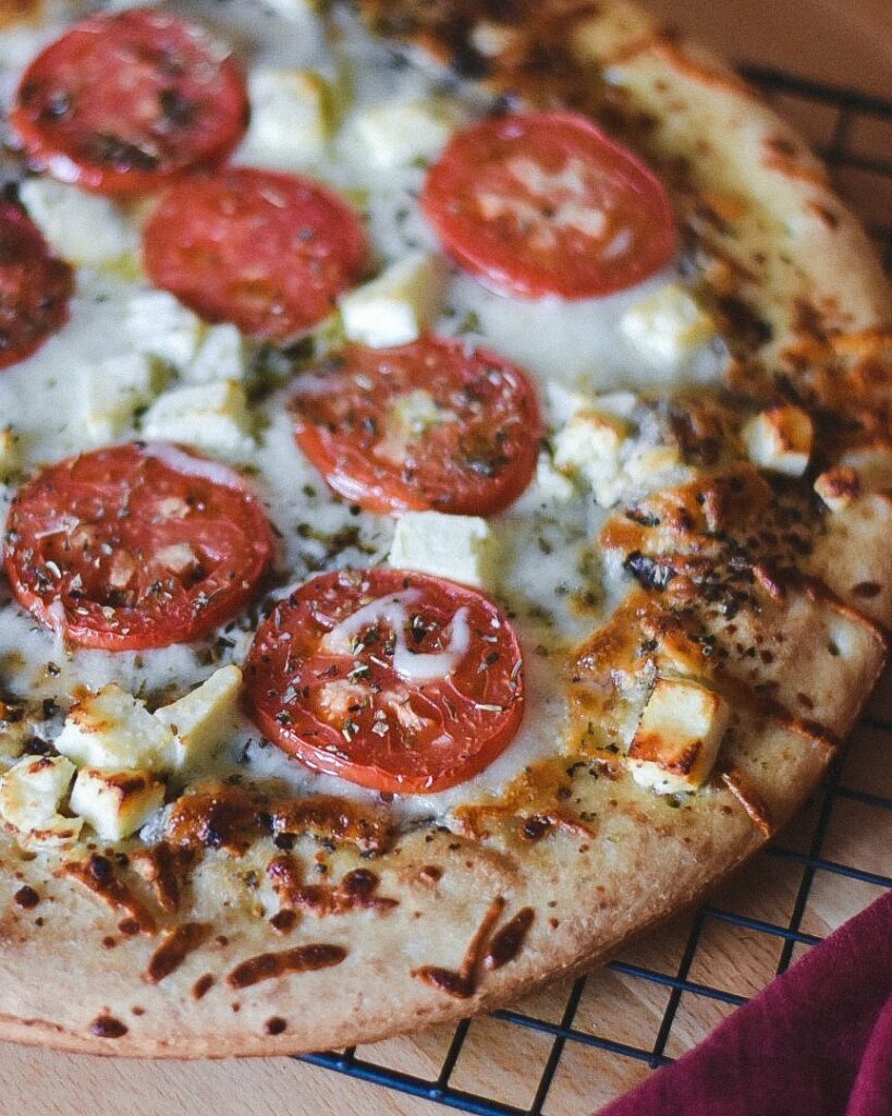 A delectable pizza topped with ripe tomatoes and creamy feta cheese. The perfect combination of flavors for pizza lovers to enjoy. Tomato and Feta Pizza Recipe