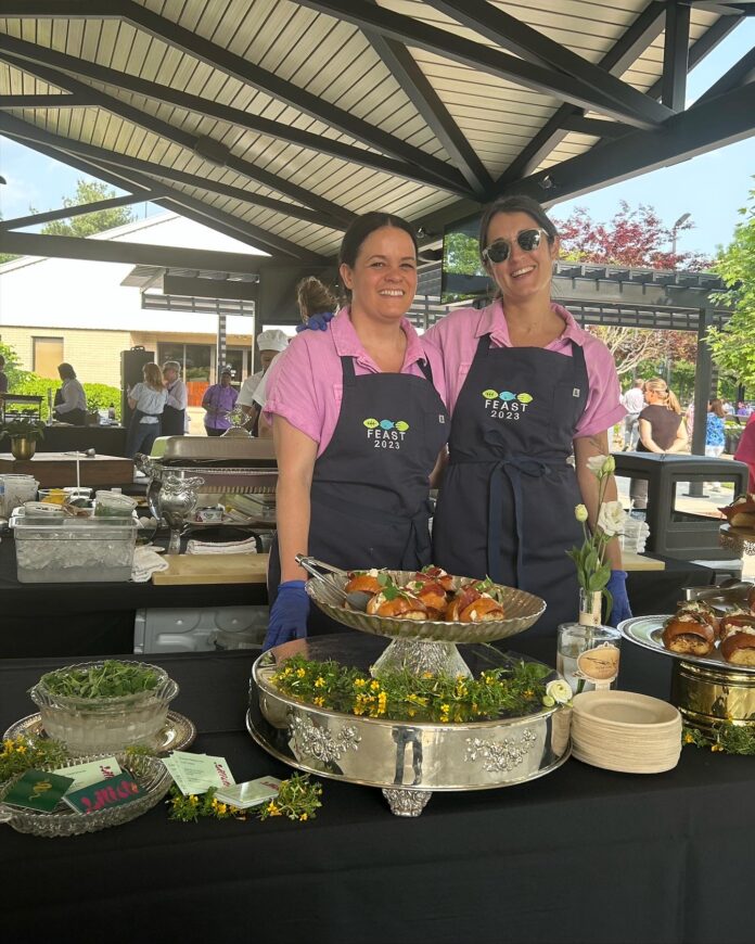 Pittsburgh chefs Jamilka Borges and Dianne DeStefano stand under a tent serving food ahead of the opening of their new restaurant. Lilith Pittsburgh
