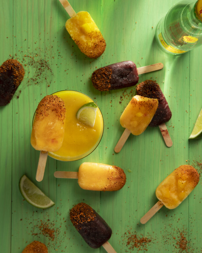 Paleta Popsicles Various dark red and orange colored fruit popsicles sit on green wood. Paleta Popsicles Recipe