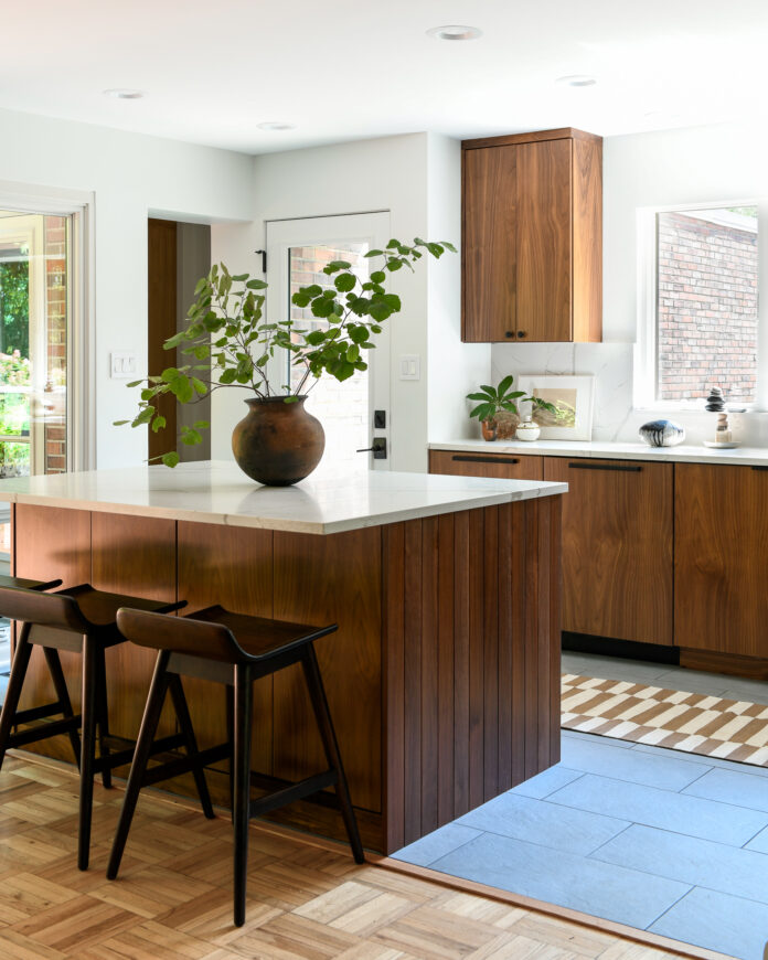 A new kitchen with wooden cabinetry, white quartz countertops.