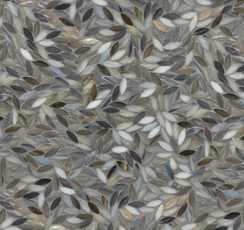 Artistic Tile’s Foliage Detroit Blue Mosaic frames the warmth of ivory and tan stained glass tesserae with the gentle cool notes of grays and blues in the same material. 2023 fall winter trends