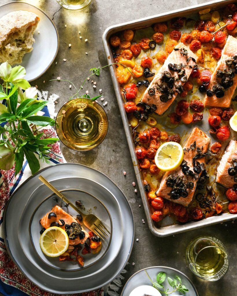 A vibrant and nutritious pan salmon and tomato meal featuring perfectly roasted salmon fillets accompanied by a colorful assortment of ripe tomatoes.